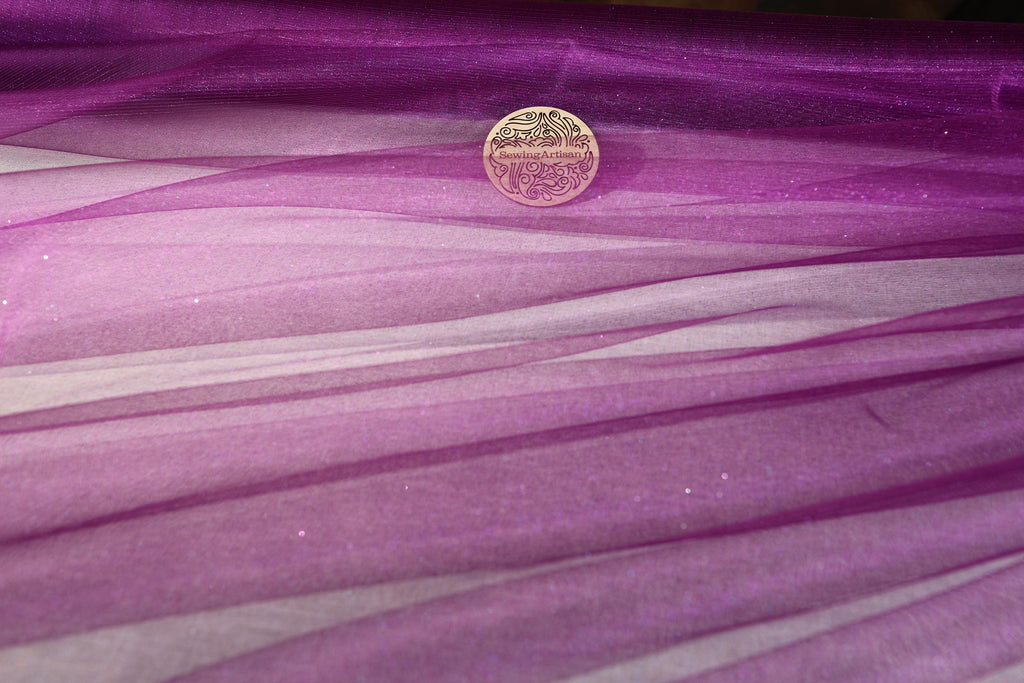 a coin sitting on top of a purple cloth