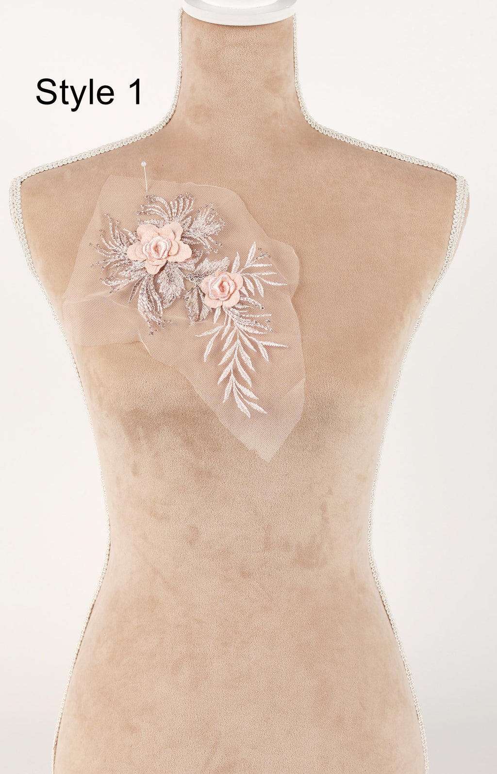 A mannequin with a decorative floral embroidered on its chest.