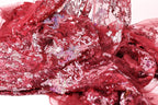 The image is a close-up of a red fabric with a floral pattern, featuring a mix of sequins and lace.