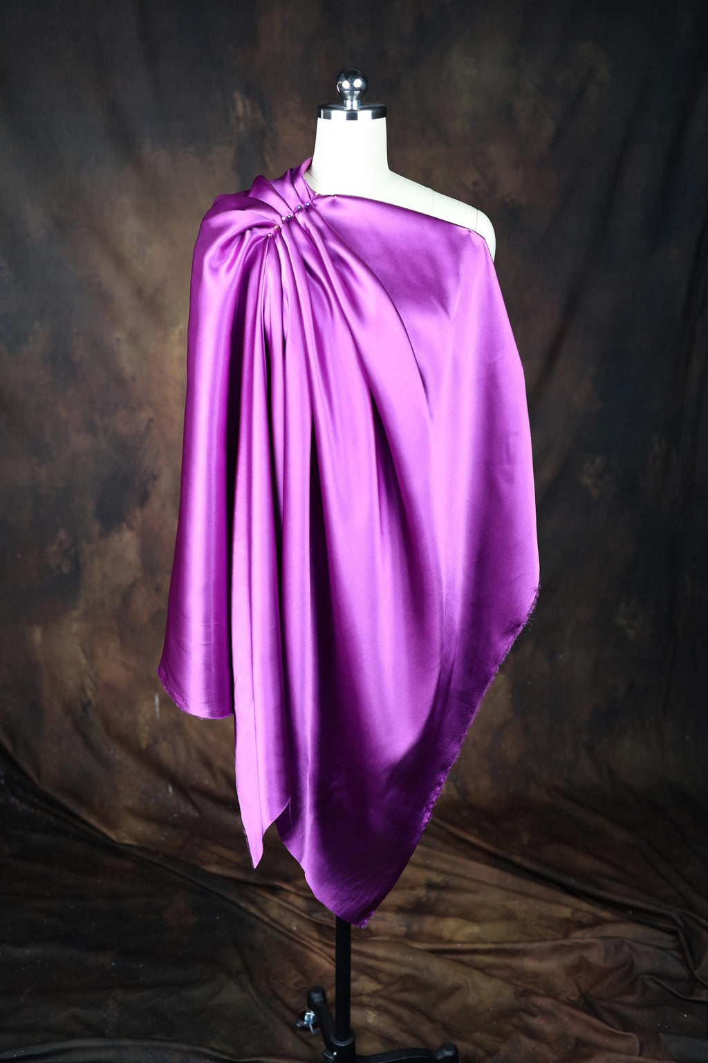 a mannequin with a purple cloth draped over it