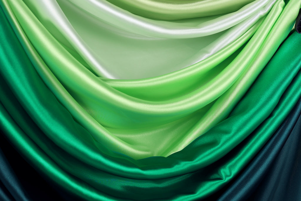 a close-up view of a fabric with a gradient of green and blue colors, creating a visually appealing and textured appearance.