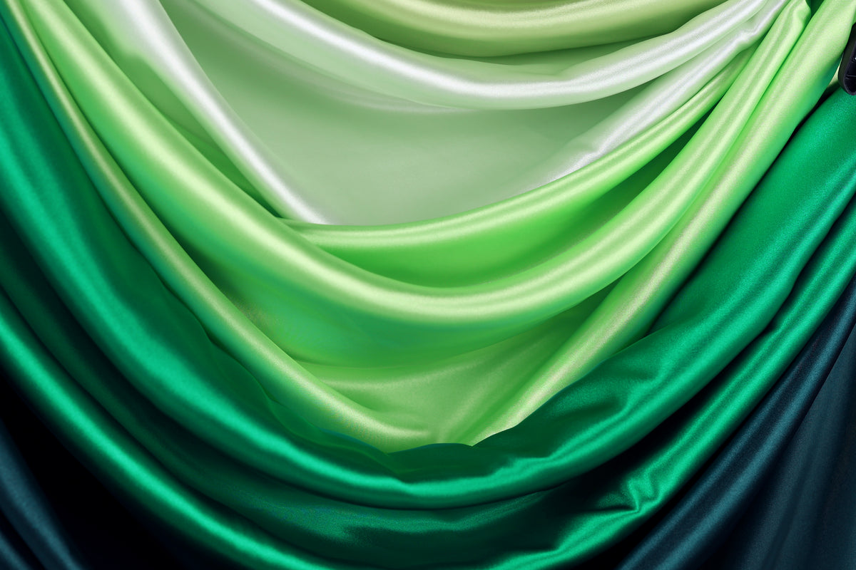 a close-up view of a fabric with a gradient of green and blue colors, creating a visually appealing and textured appearance.