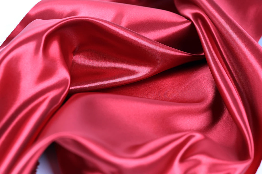 a close-up view of a shiny, red satin fabric.