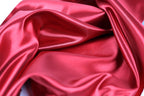 a close-up view of a shiny, red satin fabric.