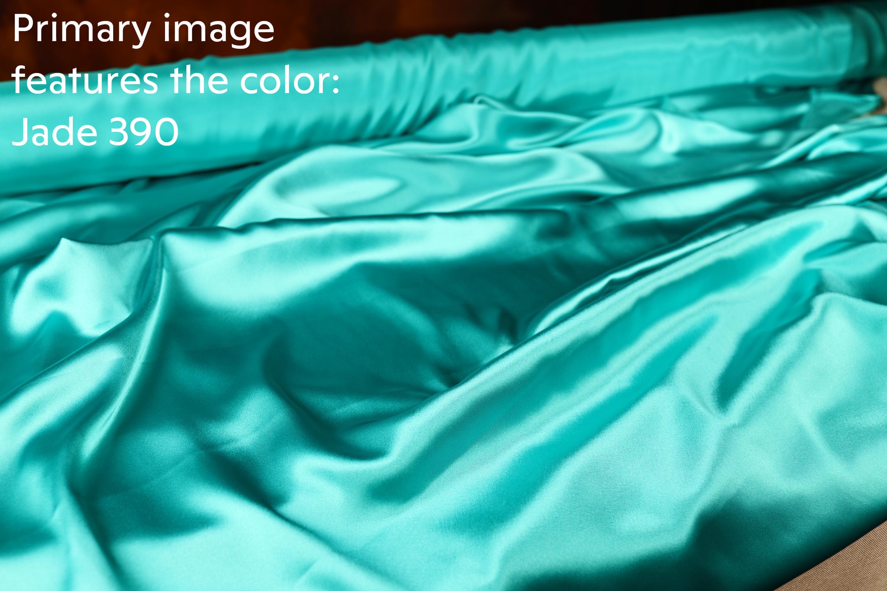 a close-up view of a turquoise satin fabric, with a text overlay that reads &quot;Primary image features the color: Jade 390&quot;.
