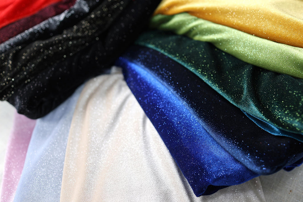 a pile of different colored cloths sitting on top of each other