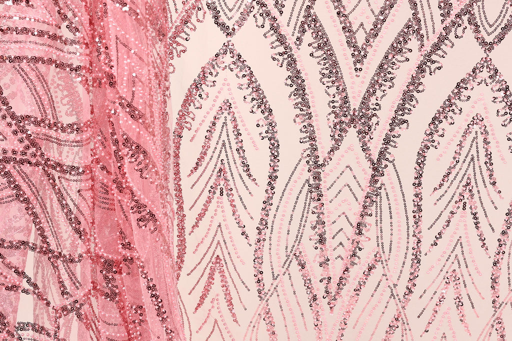 a close-up view of a fabric with a pink and black sequin pattern. The fabric appears to be a sheer material, with a repeating pattern of sequin shapes in shades of pink and black. The pattern is intricate and detailed, with the sequins arranged in a way that creates a visually striking and textured appearance.