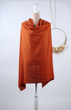 a mannequin wearing a red shawl, which is displayed on a white mannequin stand.