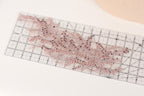 a clear ruler with a pink and purple floral pattern or design on it, placed on a white surface.