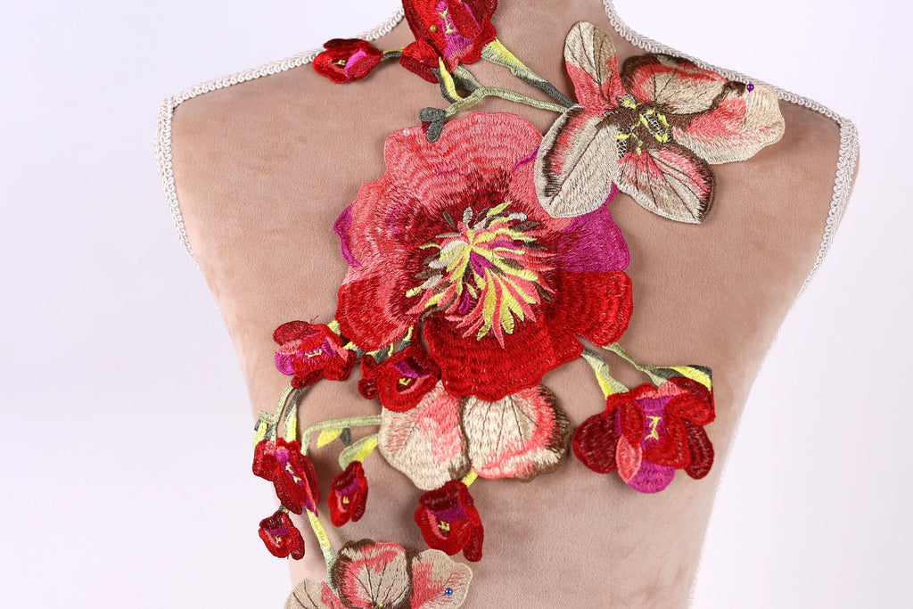 a mannequin with a large, colorful floral embroidered on its back.