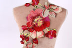 a mannequin with a large, colorful floral embroidered on its back.