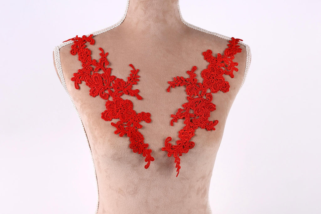 A mannequin with red floral embroidery on its shoulders.