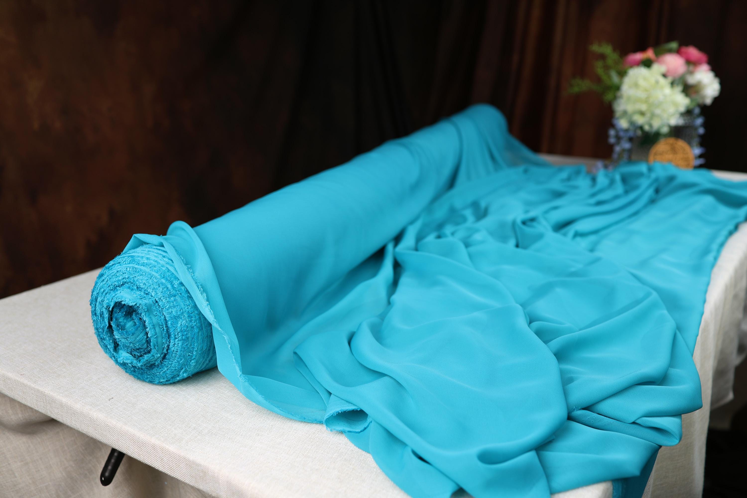 a rolled up blue blanket sitting on top of a table