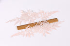 delicate, intricate lace pieces with a floral pattern, arranged on a white background. A wooden ruler is placed in the center of the lace, providing a scale reference for the size of the lace pieces.