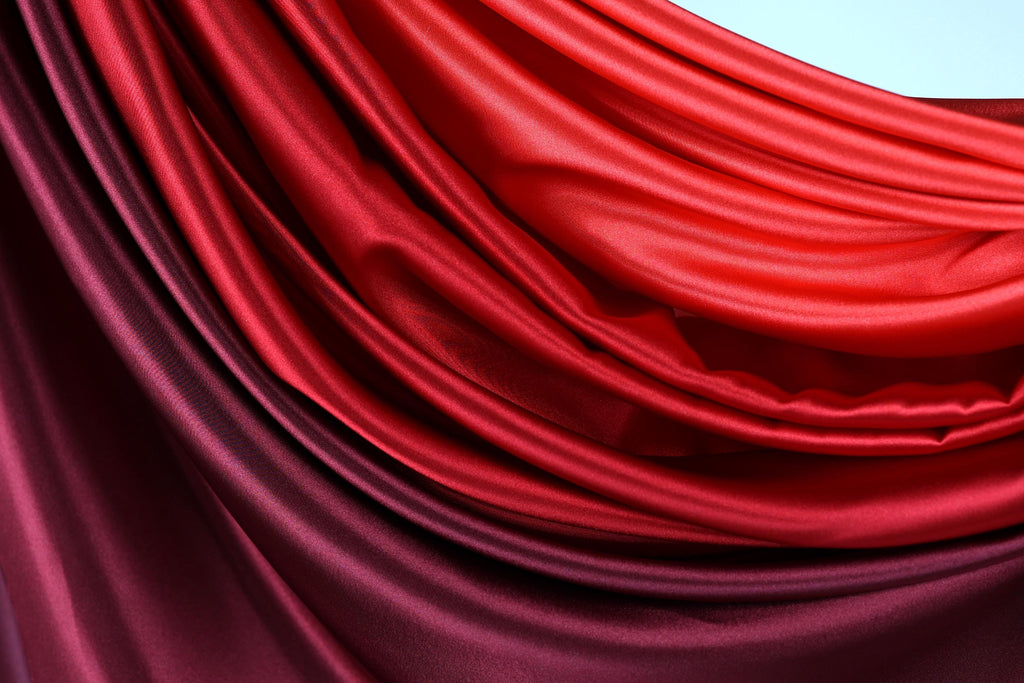 a close-up view of a fabric with a blend of red and purple colors, creating a visually striking and vibrant appearance.