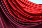 a close-up view of a fabric with a blend of red and purple colors, creating a visually striking and vibrant appearance.