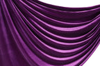 a close-up view of a shiny, purple satin fabric with a smooth, flowing texture.