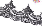 a close-up view of a black lace trim with intricate floral and lace-like patterns.