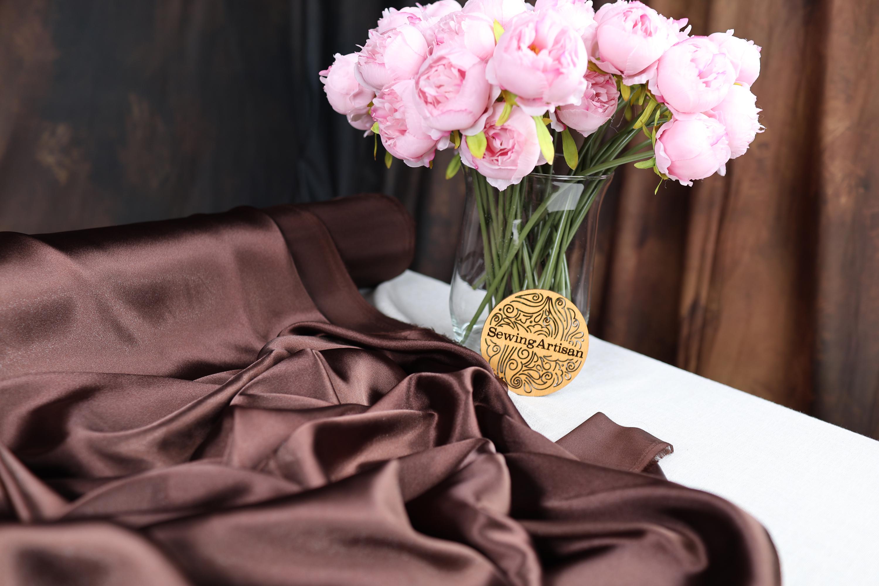 a vase filled with pink flowers on top of a table