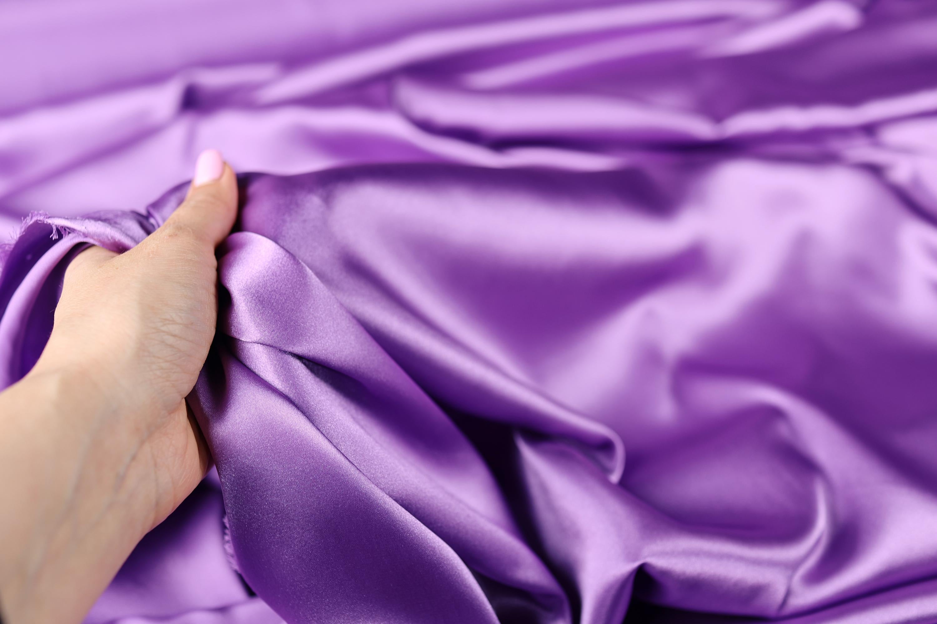 a person holding a purple cloth in their hand