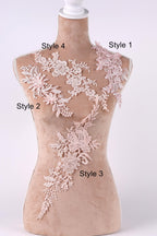 A mannequin with various lace and floral designs on its bust and shoulders, each labeled with a different style number.