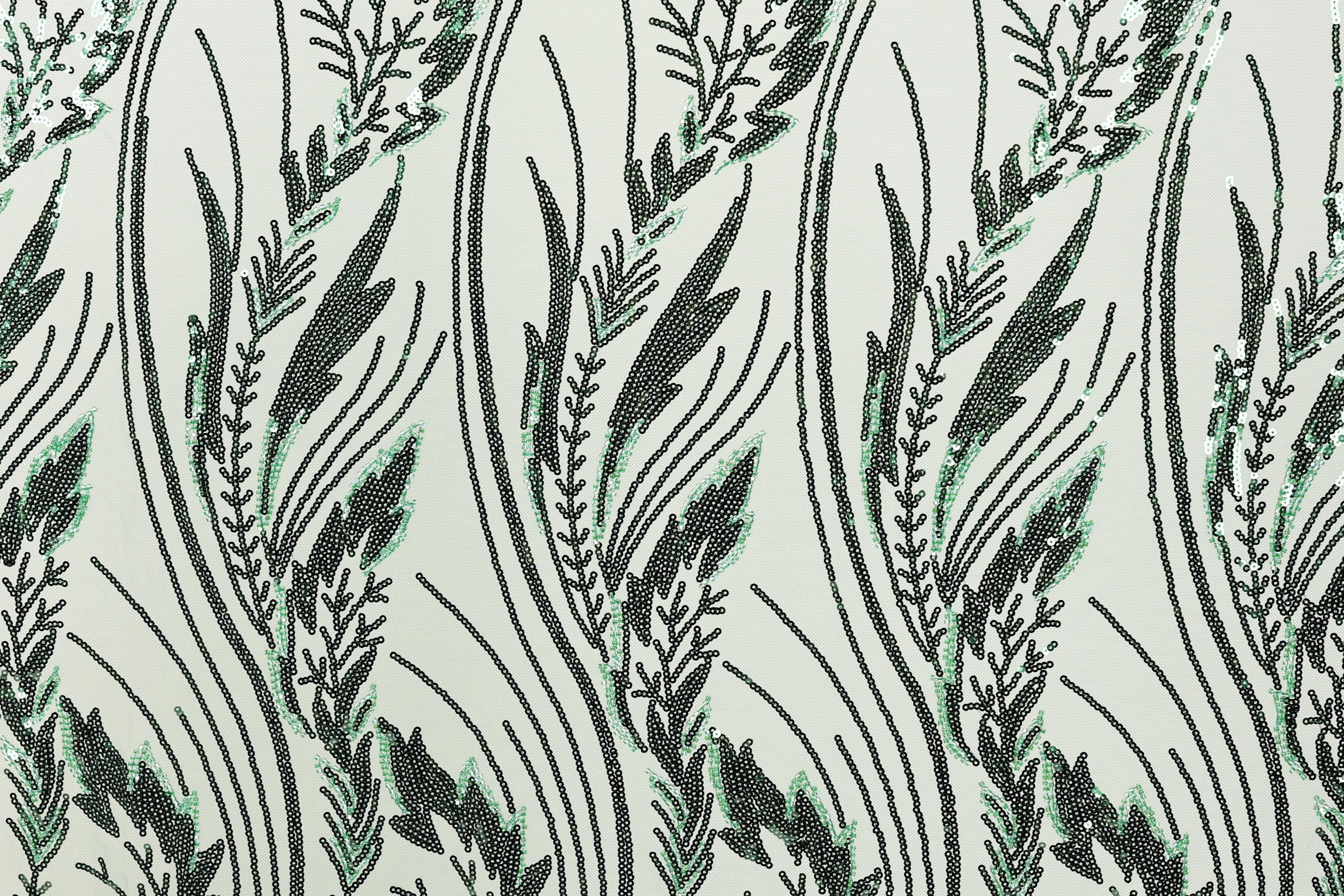 a repeating pattern of stylized green and black lines and shapes, creating a visually striking and intricate design.