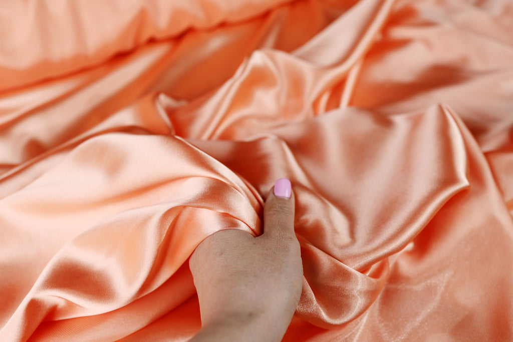 a person&#39;s hand with a pink manicure on it