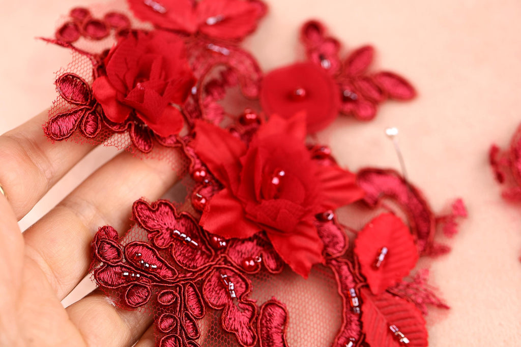 a hand is holding a piece of red fabric