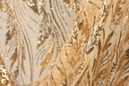 a close-up view of a fabric with a gold and black sequin pattern, creating a visually striking and intricate design.