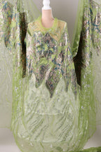 a green and silver dress with intricate patterns and designs, including a floral and leaf motif.