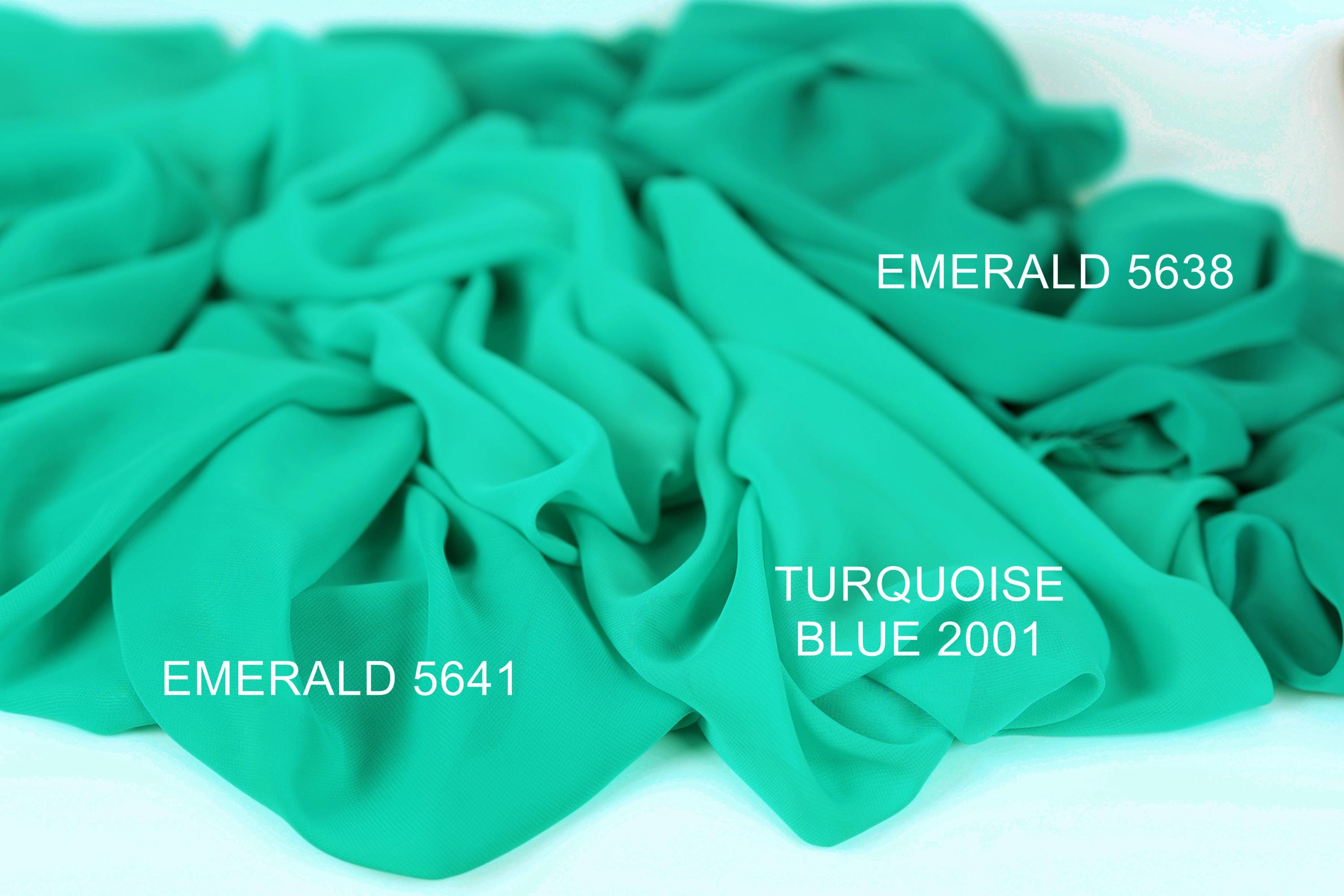 a close-up of a crumpled piece of turquoise fabric, with text indicating the color and brand of the fabric.