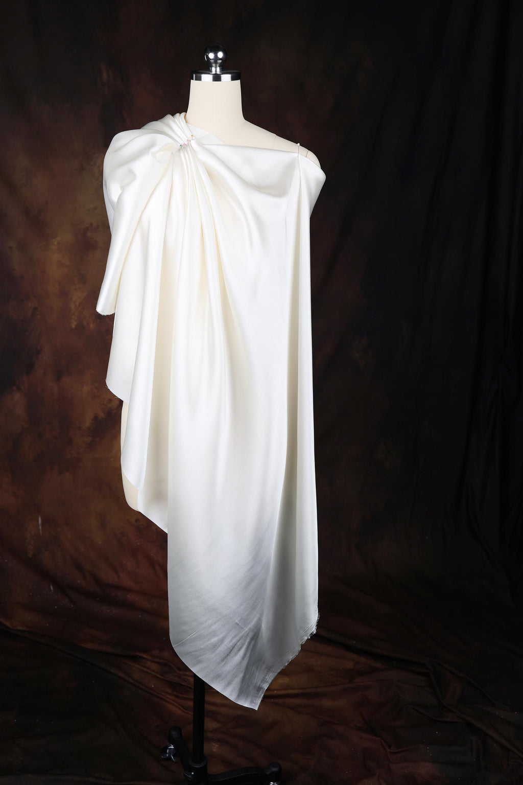 a white dress on a mannequin on a black background