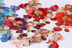 a variety of colorful, intricately embroidered flowers in shades of red, pink, blue, and purple.