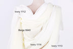 a close-up view of a white fabric, possibly a dress or garment, with three different shades of white visible. The text labels the different shades, indicating their names: Ivory 1112, Beige 9940, and Ivory 1114.