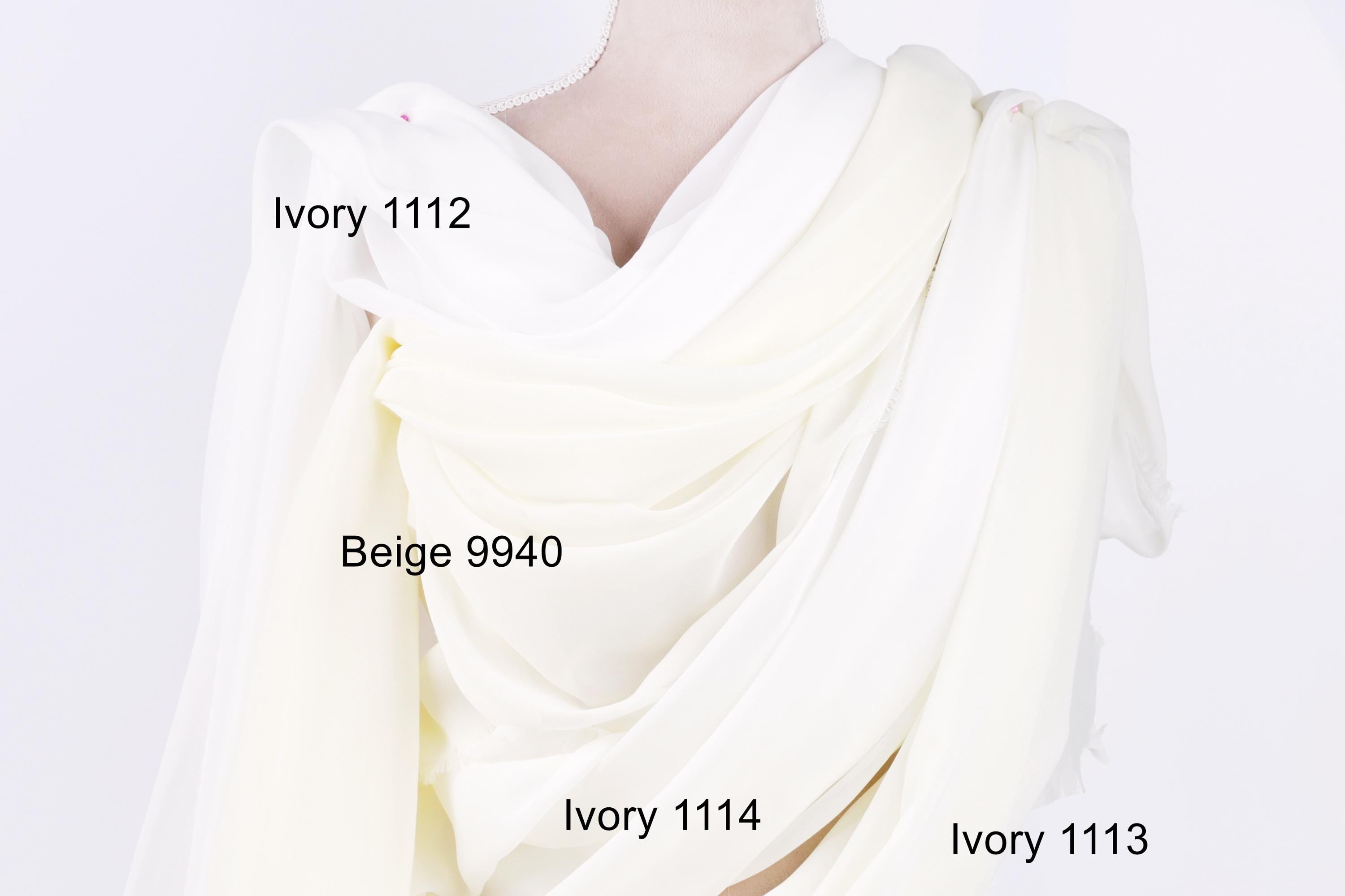 a close-up view of a white fabric, possibly a dress or garment, with three different shades of white visible. The text labels the different shades, indicating their names: Ivory 1112, Beige 9940, and Ivory 1114.