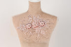 A mannequin with a delicate, floral-patterned fabric draped over its torso.