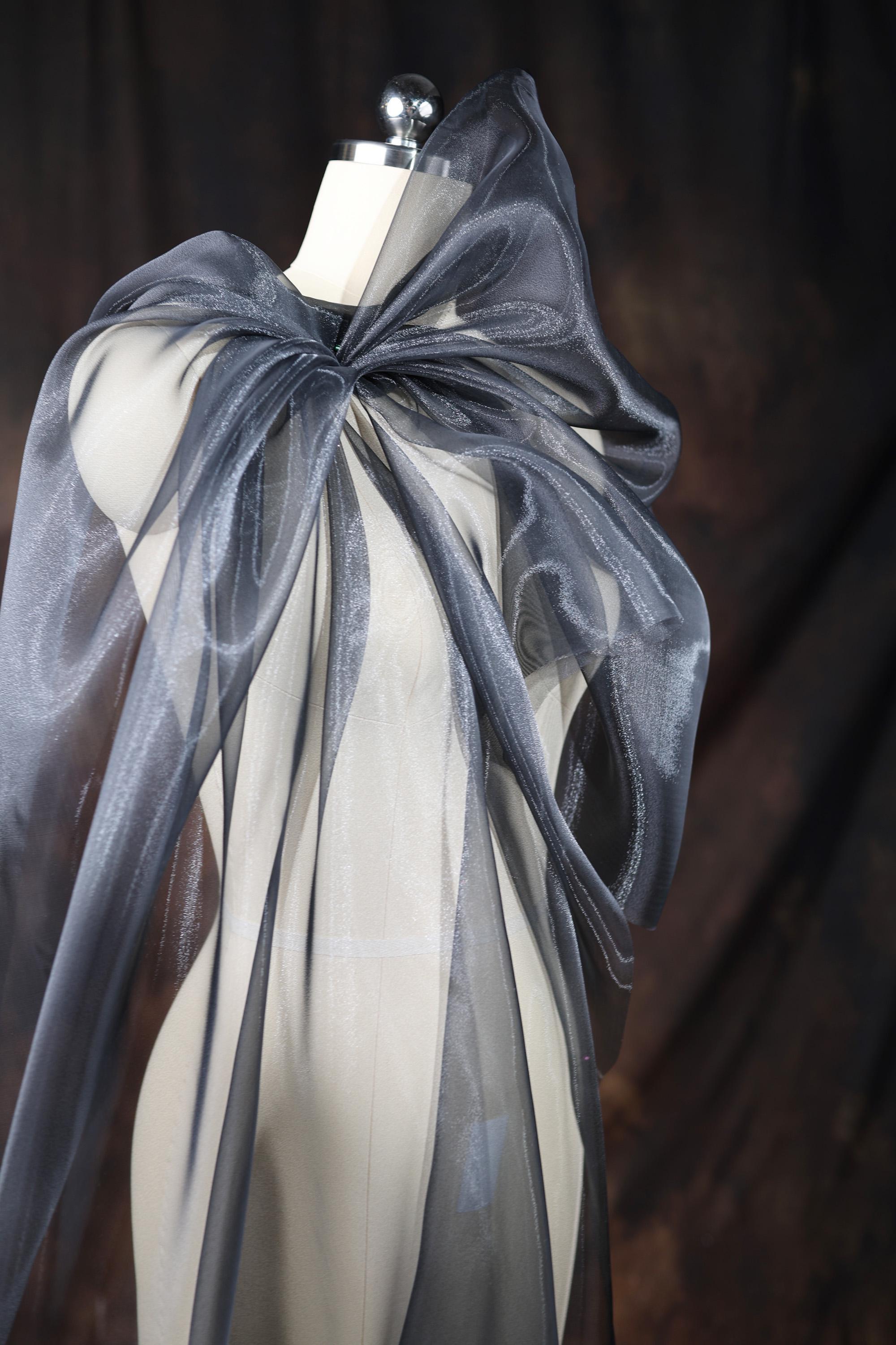a mannequin wearing a gray and white dress