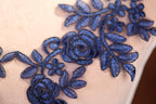 a close up of a dress with blue flowers on it