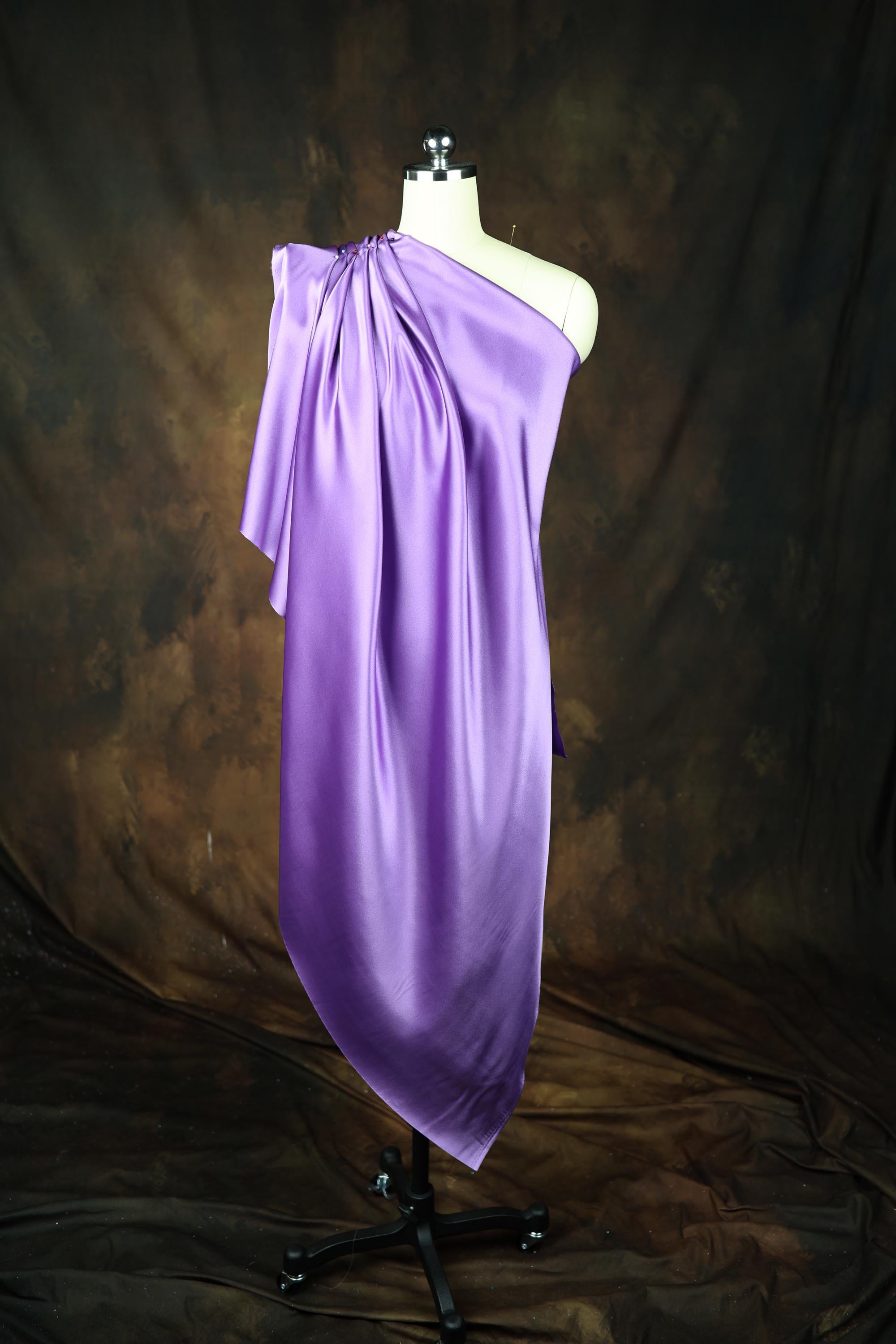 a dress on a mannequin on a black background