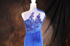 a blue dress with purple flowers on it