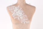 A mannequin torso with a delicate, floral-patterned fabric attached to it.
