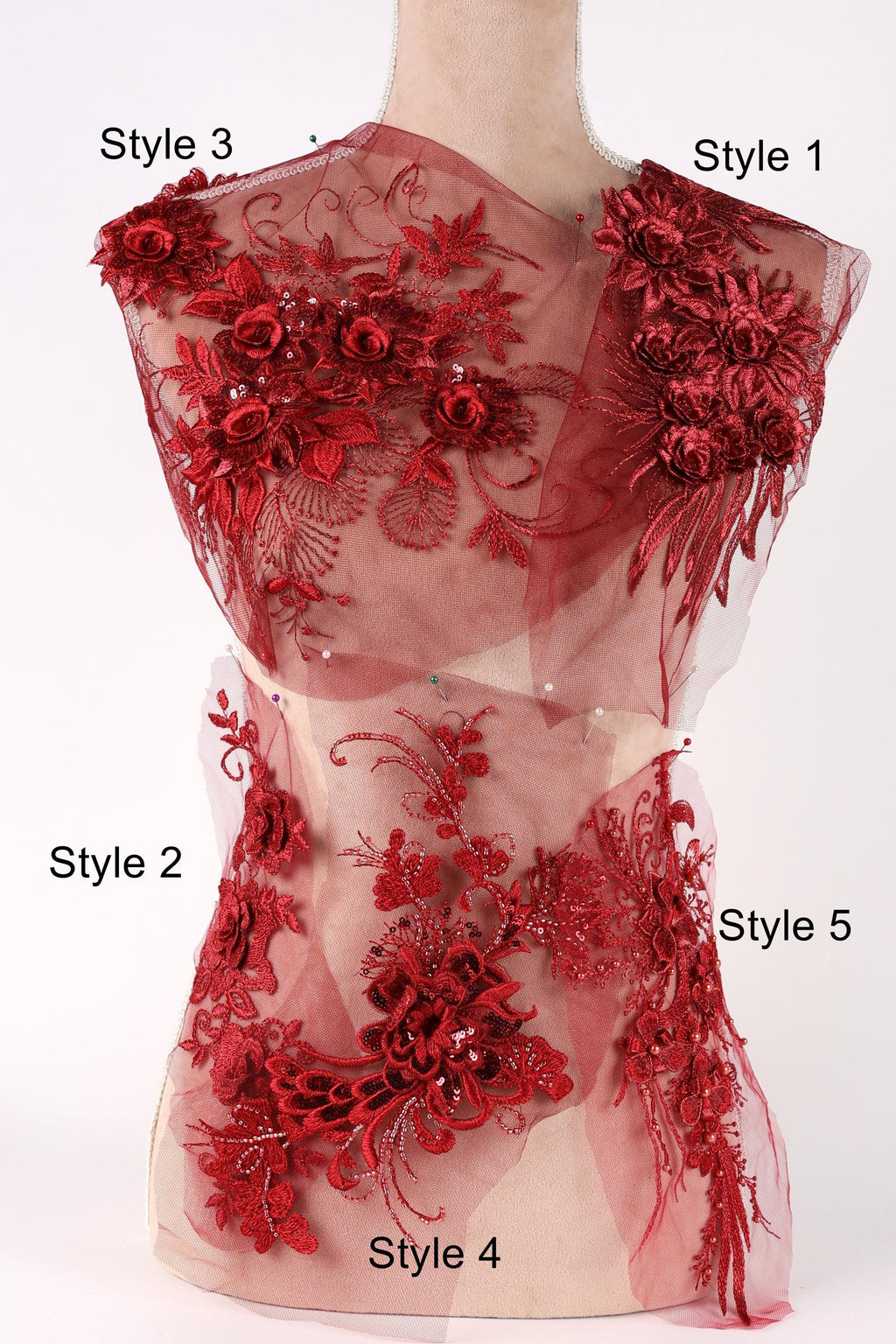 A mannequin with a red floral dress featuring various styles of embroidery and lace.