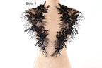 A mannequin wearing a black lace collar with intricate floral patterns.