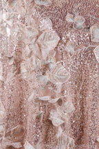 The image is a close-up of a delicate, pink sequined dress with intricate floral embroidery.