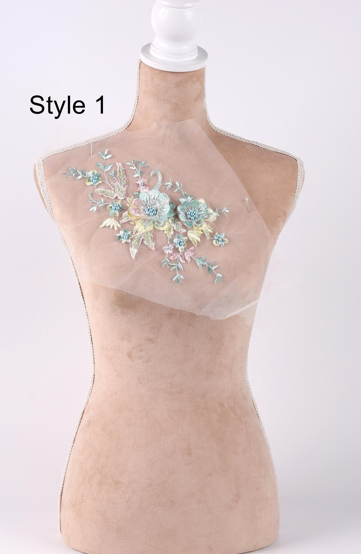 A mannequin with a floral embroidered patch on its bust.