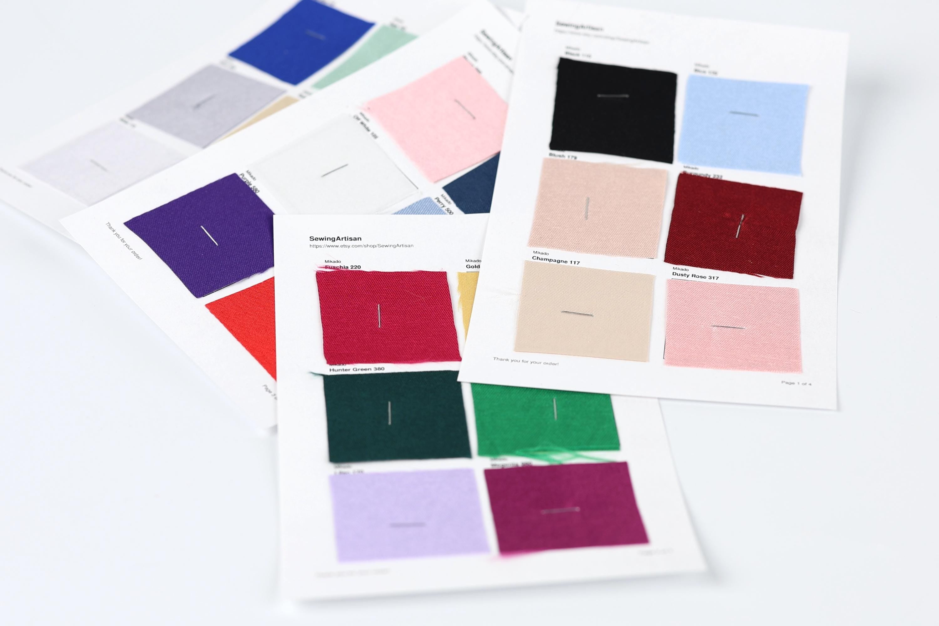 a collection of fabric swatches, each with a different color, arranged on a white background.