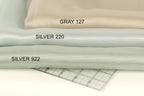 three different fabric swatches, each with a label indicating the color: Gray 127, Silver 220, and Silver 922.