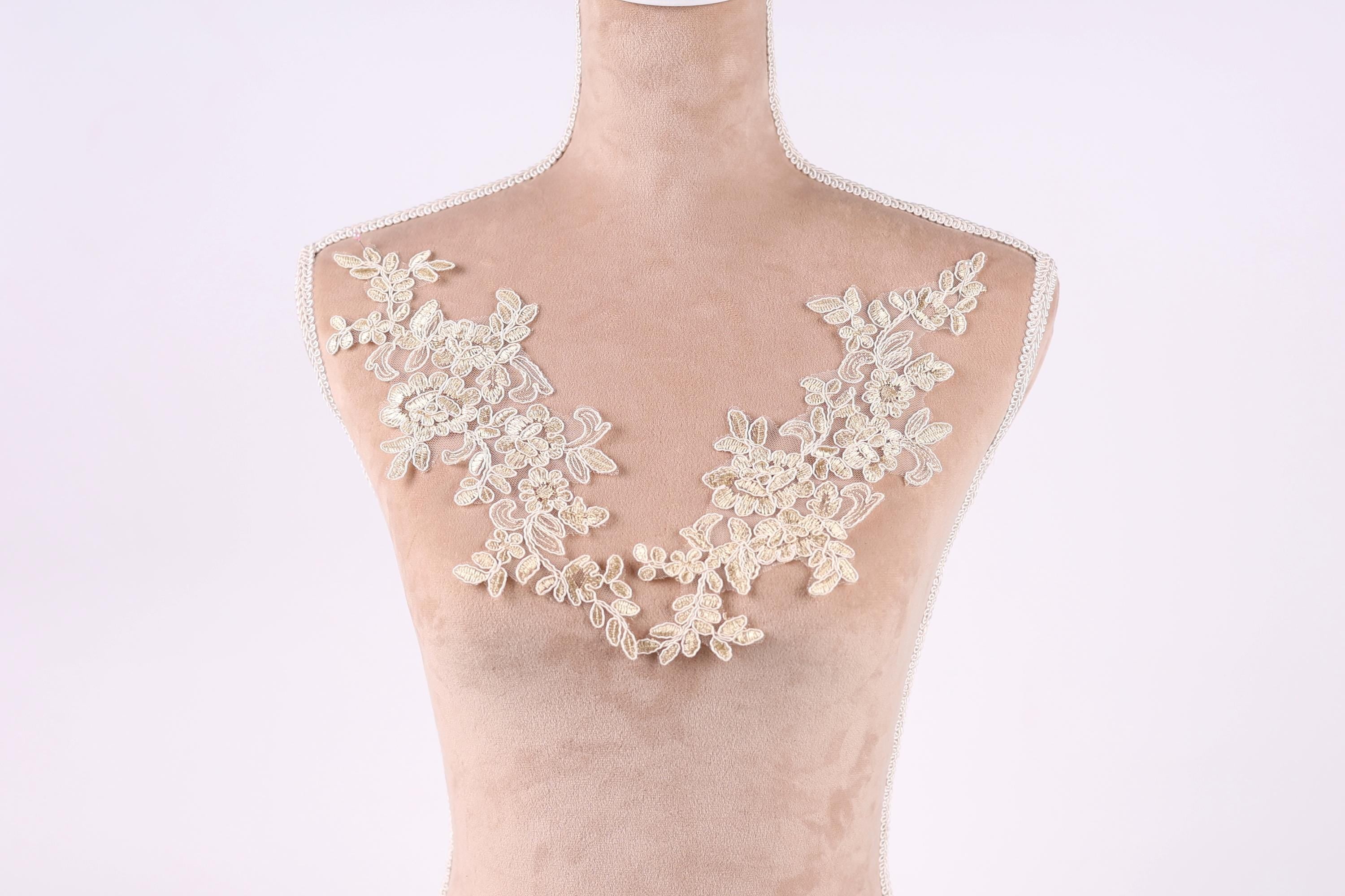 A mannequin with a delicate, lace-like design on its chest area.