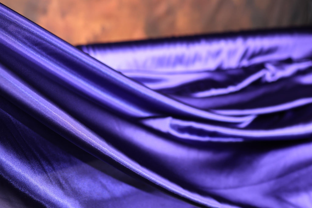 a close up of a purple satin material