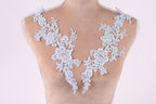 A mannequin wearing a necklace with delicate white lace pieces.